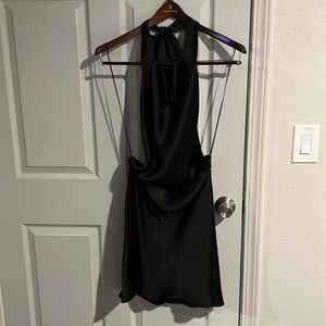 Sleeveless halter mini dress with tie open back. Hidden in-seem zip closure.